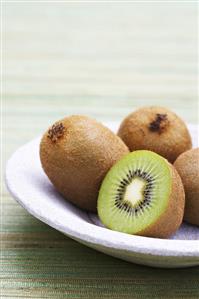 Kiwi fruits, whole and halved