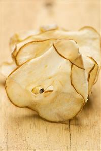 Dried pear slices on a wooden background