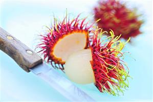 Rambutans, one peeled, one unpeeled