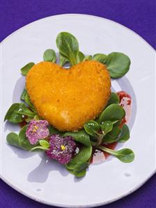 Deep-fried Camembert heart with corn salad and violets