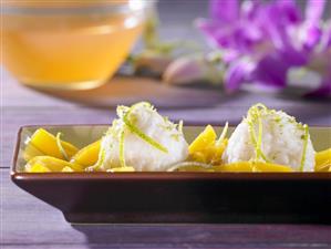 Coconut rice balls with mango compote (Asia)
