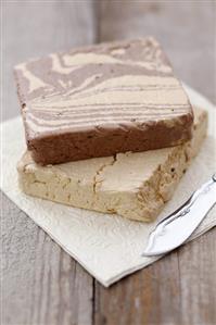 Vanilla and chocolate halva on napkin with knife