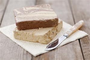 Vanilla and chocolate halva on napkin with knife
