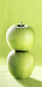 Two stacked Granny Smith apples