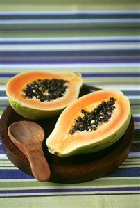 Halved papaya with spoon