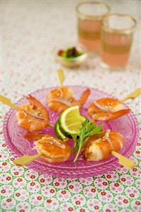 Fried shrimps on cocktail sticks with lime