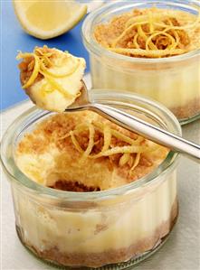 Lemon quark cream on a biscuit base in glass ramekins