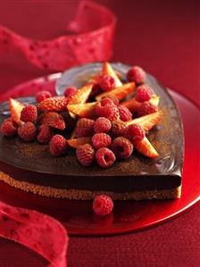 Heart-shaped chocolate cake with berries for Valentine's Day