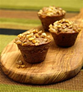 Three Banana Nut Muffins on a Cutting Board