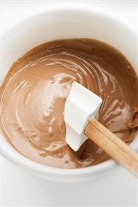 Chocolate Cake Batter in Mixing Bowl with Rubber Spatula