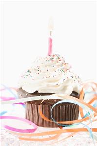 Frosted Chocolate Cupcake with a Lit Candy and Birthday Ribbon